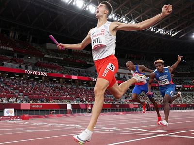 Kajetan Duszynski of Team Poland celebrates after crossing the finishing line to win gold in the 4 x 400m Mixed Relay Fi