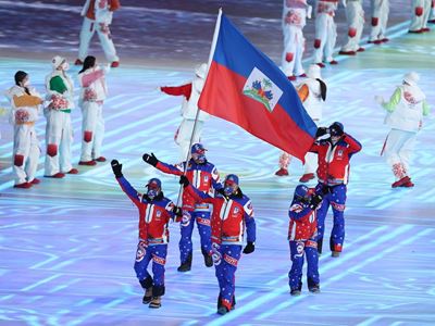 Flag bearer Richardson Viano of Team Haiti