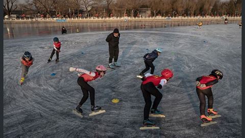 Young speed skaters train on the ice at an outdoor rink on Shichahai Lake at Houhai