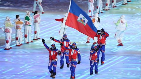 Flag bearer Richardson Viano of Team Haiti