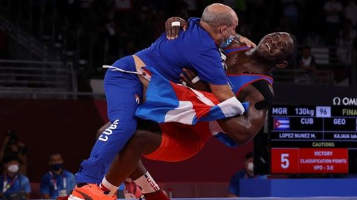 CHIBA JAPAN AUGUST 02 Mijain Lopez Nunez of Team Cuba celebrates with his coaching staff after defeating Iakobi Kaja