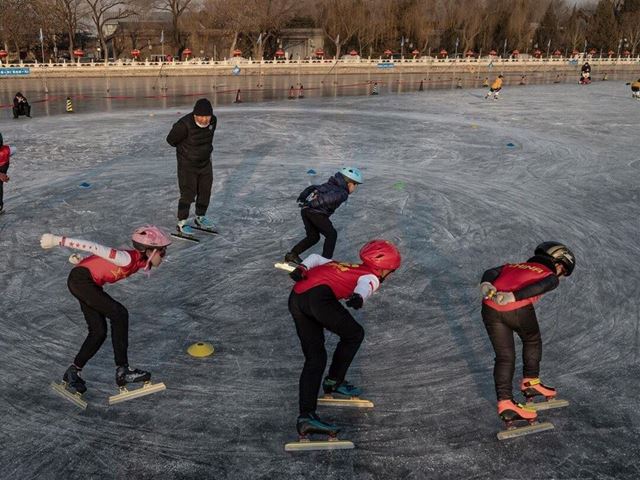 Young speed skaters train on the ice at an outdoor rink on Shichahai Lake at Houhai