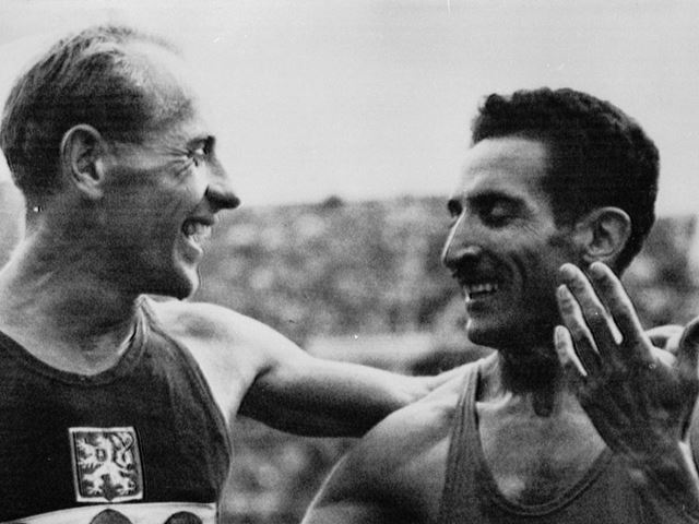 Emil Zatopek of Czechoslovakia (left) is congratulated by Alain Mimoun O'Kacha of France after winni...