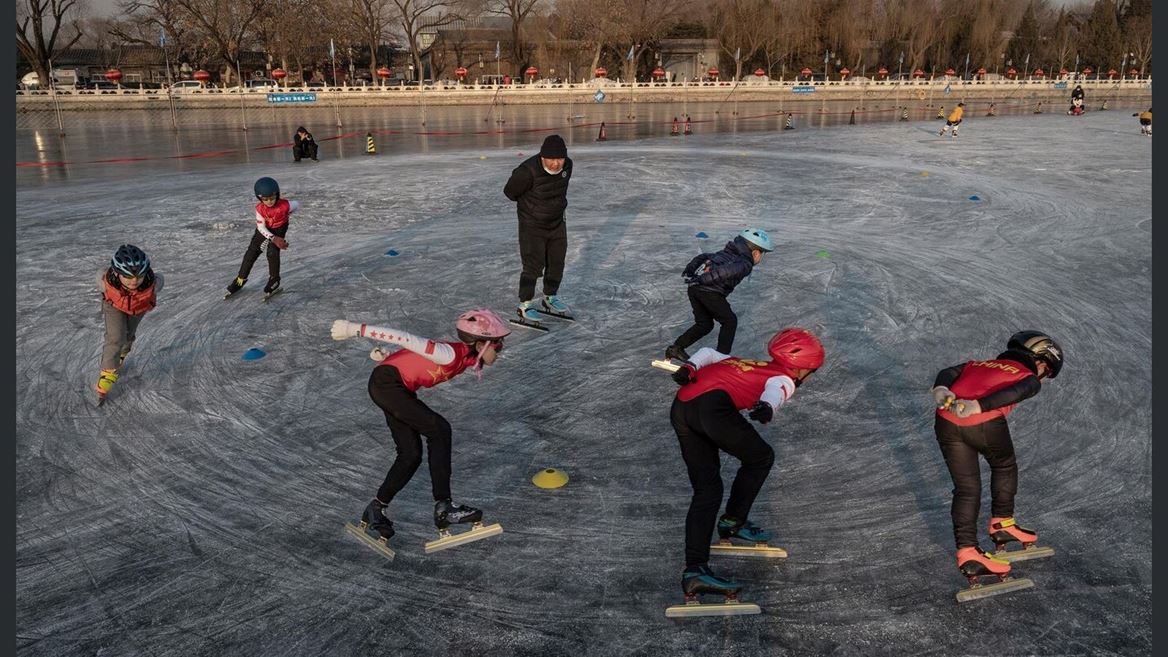Young speed skaters train on the ice at an outdoor rink on Shichahai Lake at Houhai