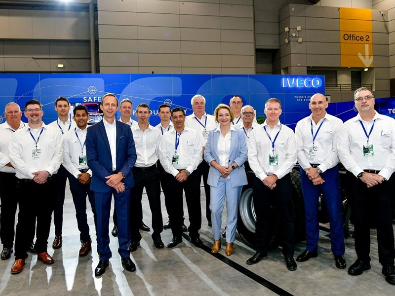The IVECO team led by Managing Director, Mike May (blue suit), prepare to meet customers