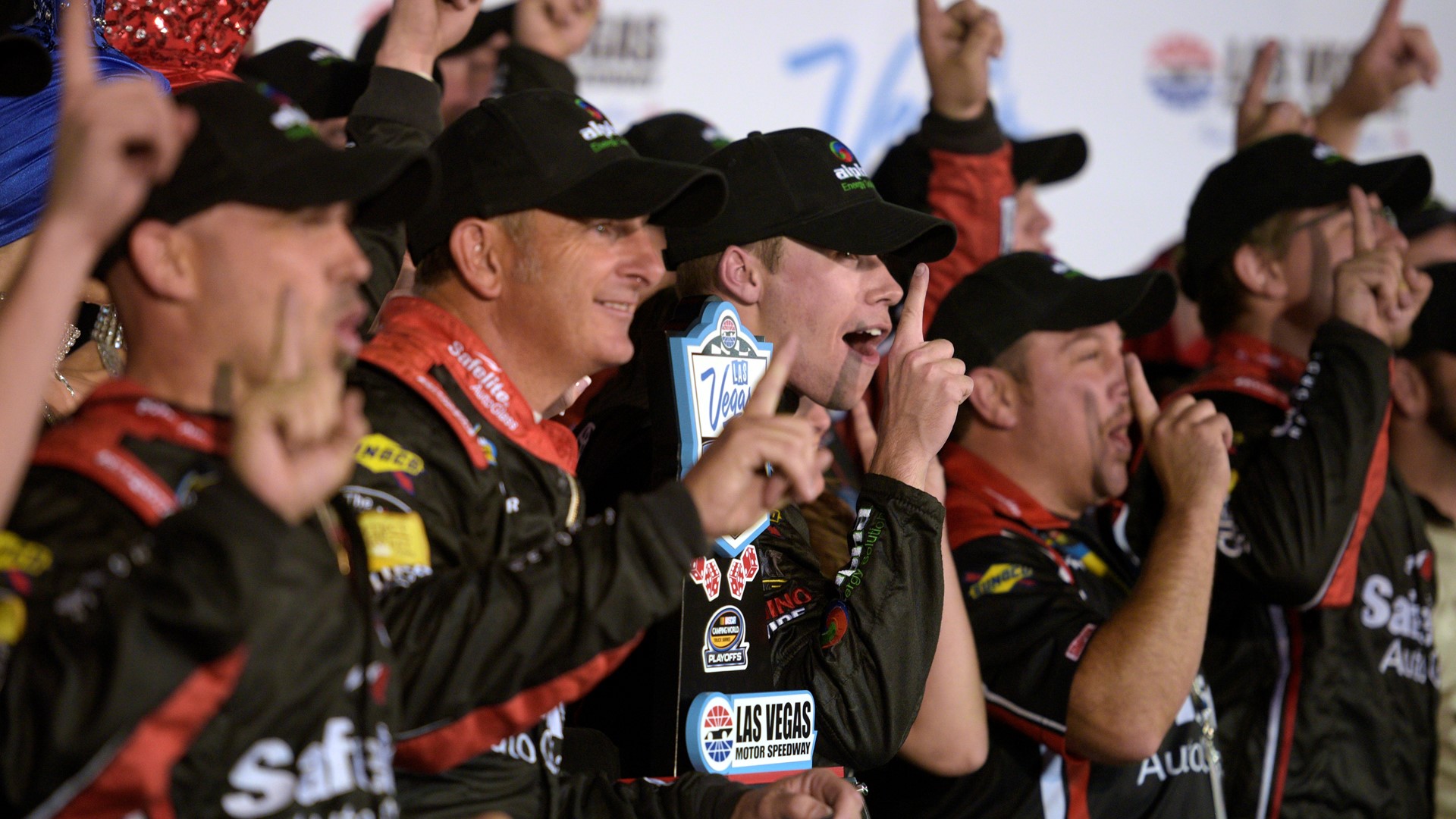 Ben Rhodes and his team cheer for photos after winning the NASCAR Camping World Truck Series