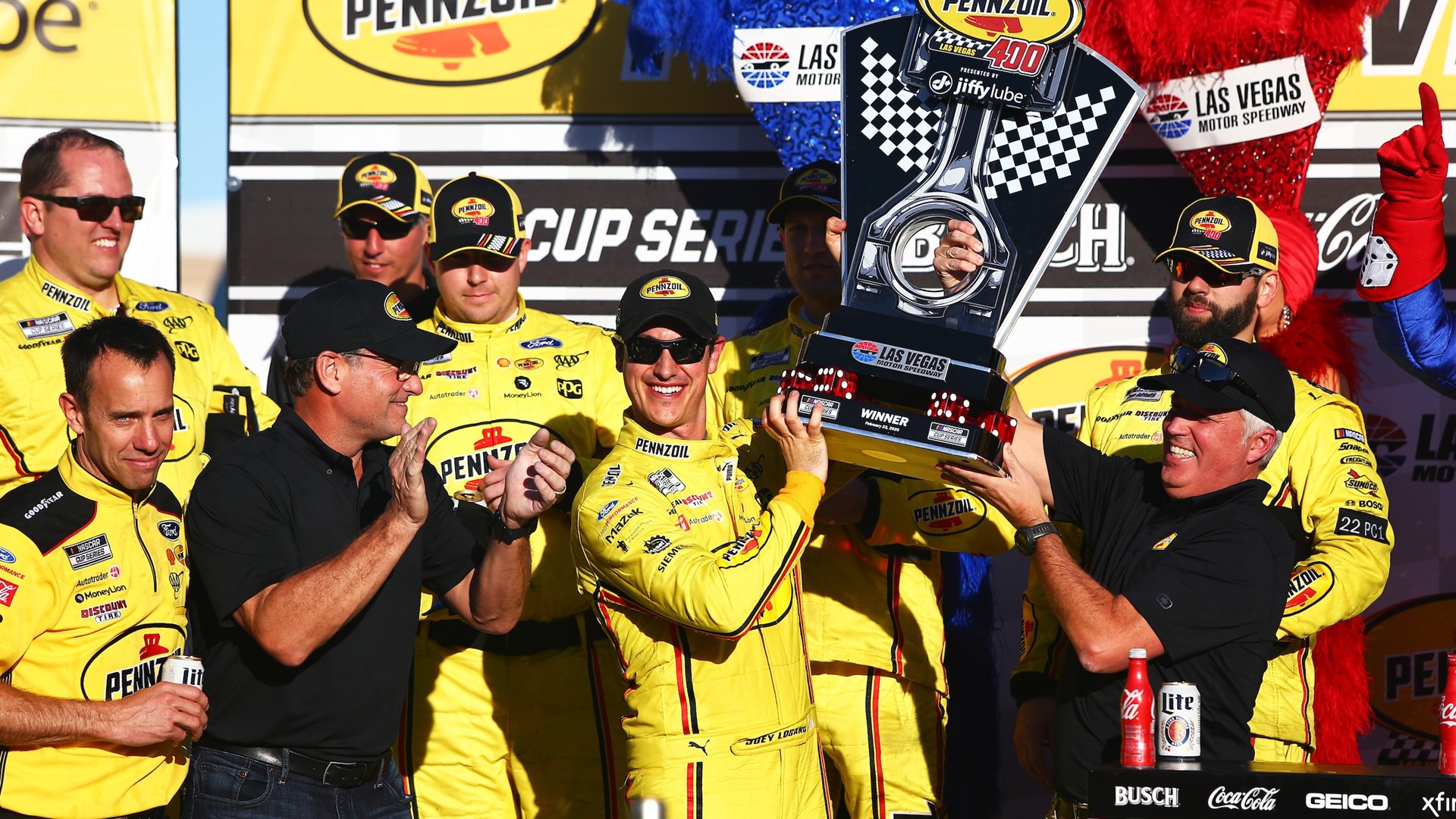 Joey Logano (22) is presented with a trophy after winning the NASCAR Cup Series Pennzoil 400