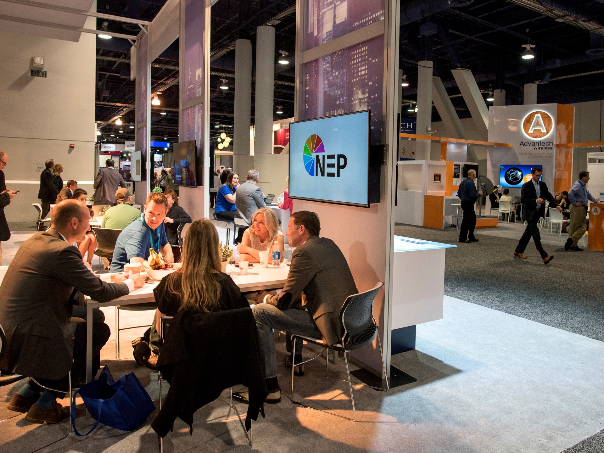 Salespeople meet in the NEP broadcast technology booth