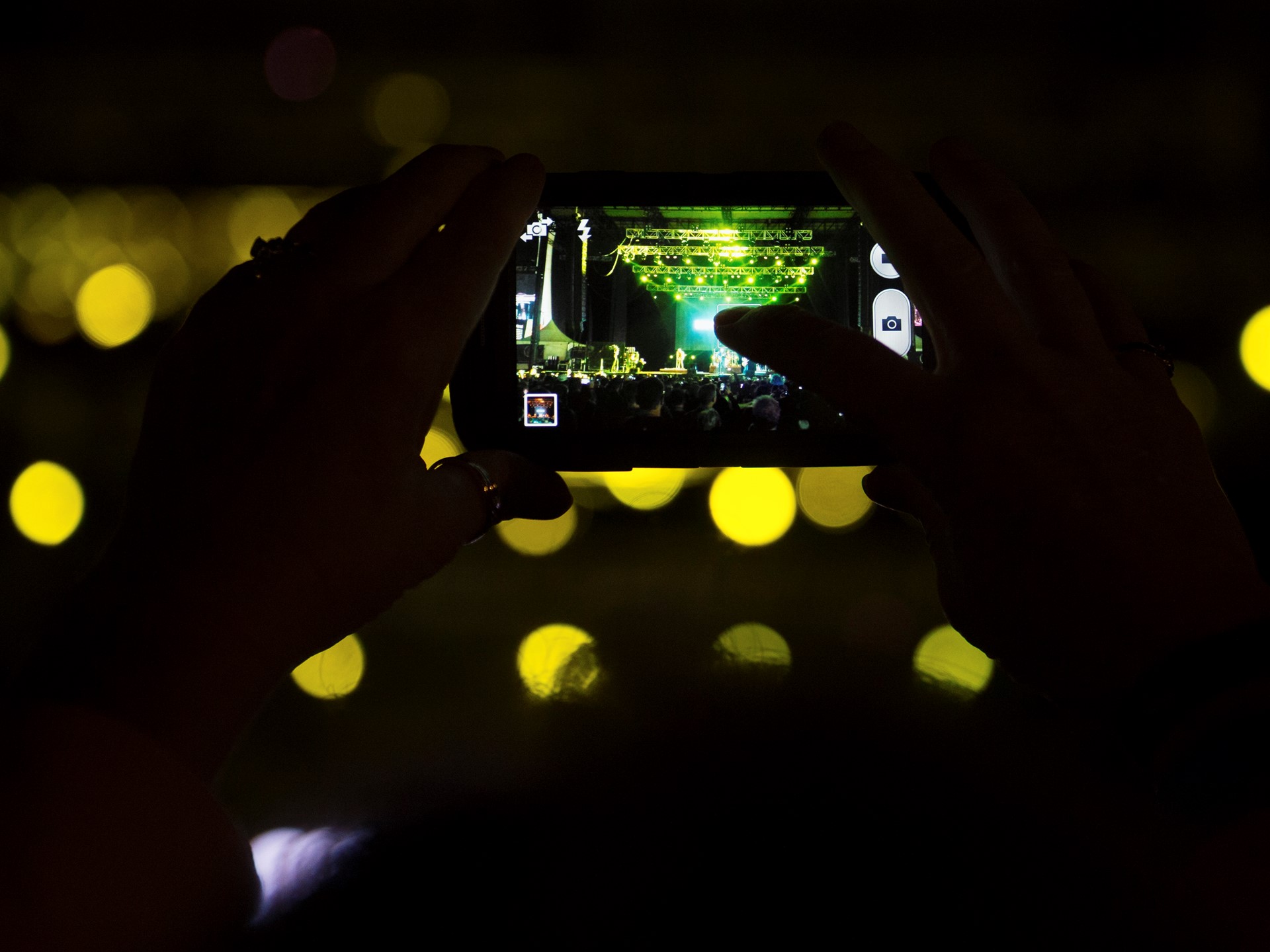 A fan takes a photo of the Goo Goo Dolls performing during the Rock 'n' Roll Las Vegas Marathon 5K run