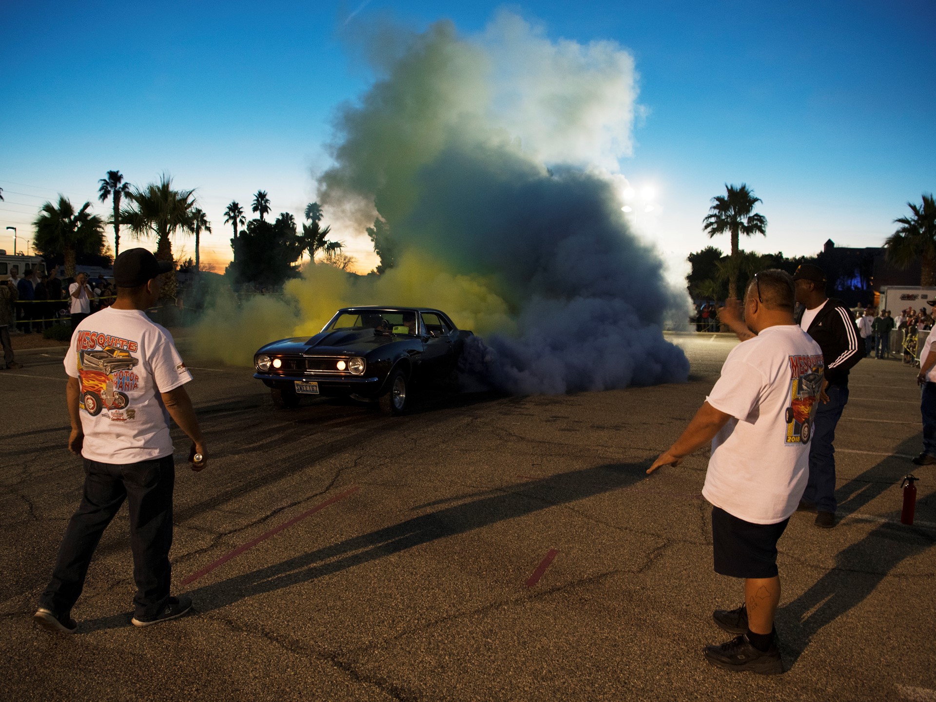 Tom Thiessen sends up clouds of yellow and blue smoke from the tires of his 1969 Camaro