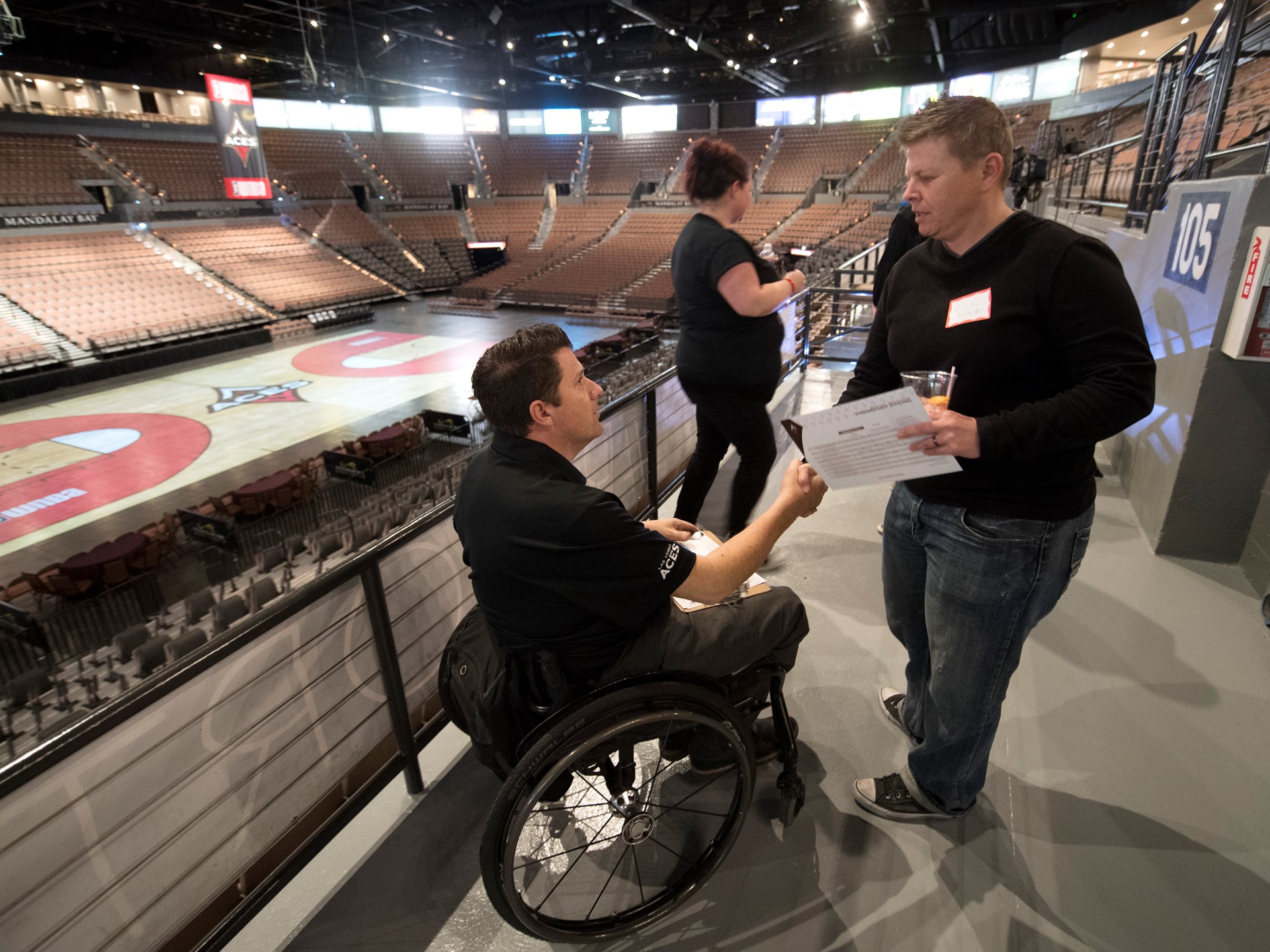 Las Vegas Aces Director of sales Aaron Johnson talks with a fan
