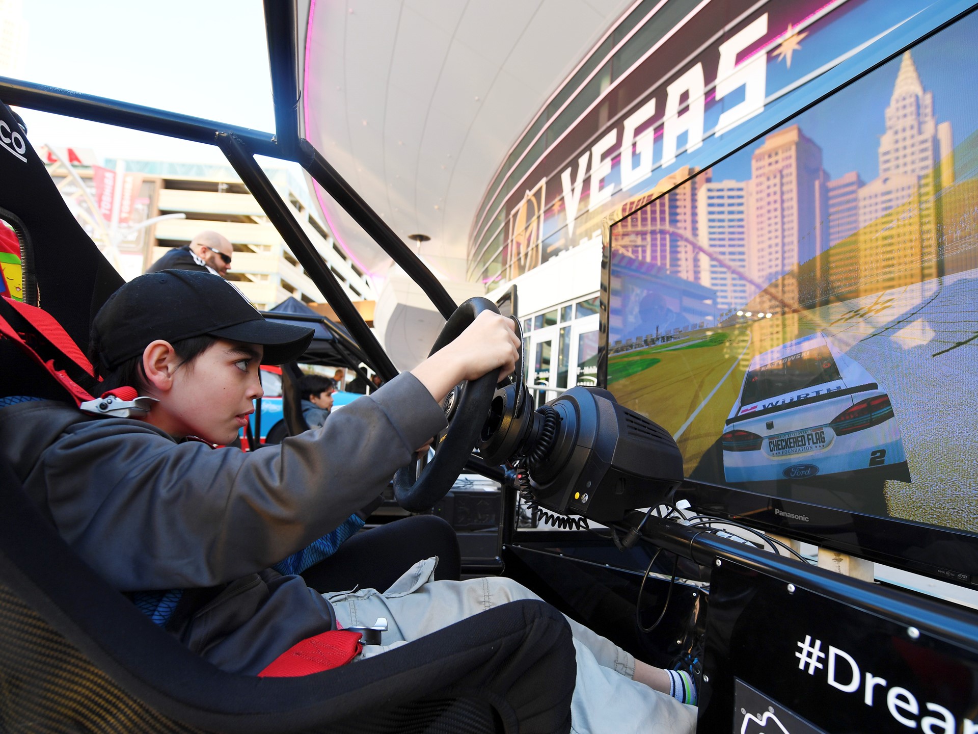 Ethan Chase of Las Vegas tries out a driving simulation