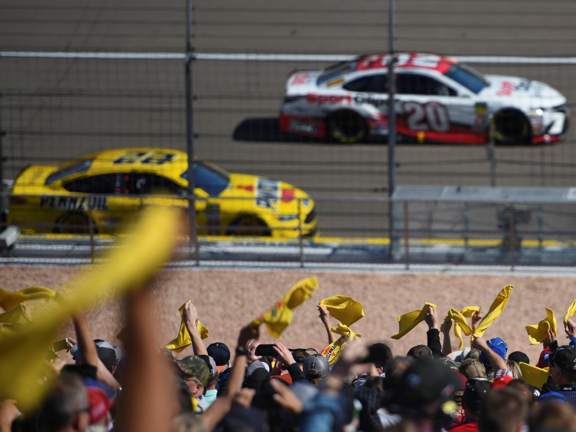 Fans wave Pennzoil flags during the Monster Energy NASCAR Cup Series Pennzoil 400