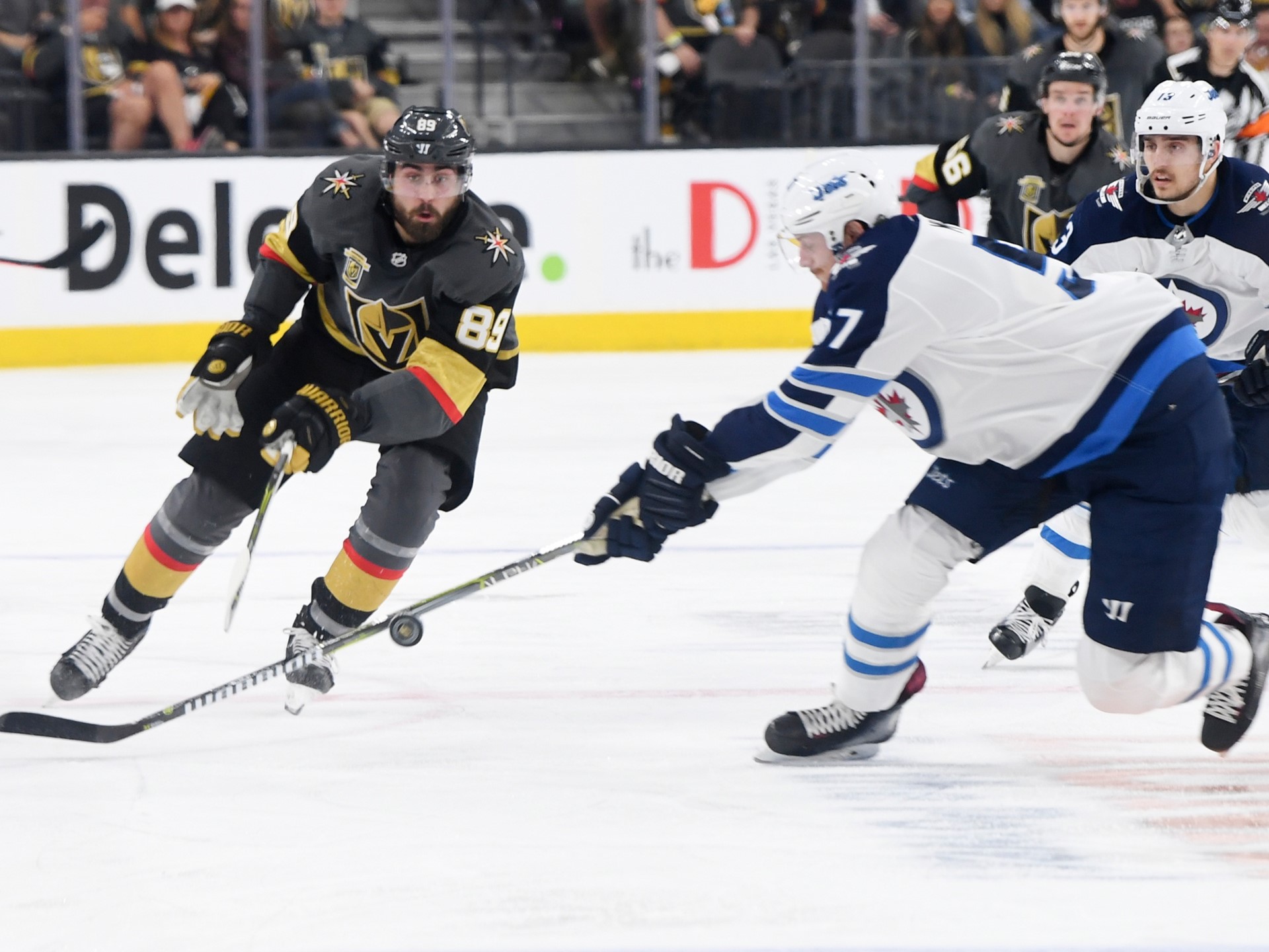 Vegas Golden Knights right wing Alex Tuch gets a pass by Winnipeg Jets defenseman