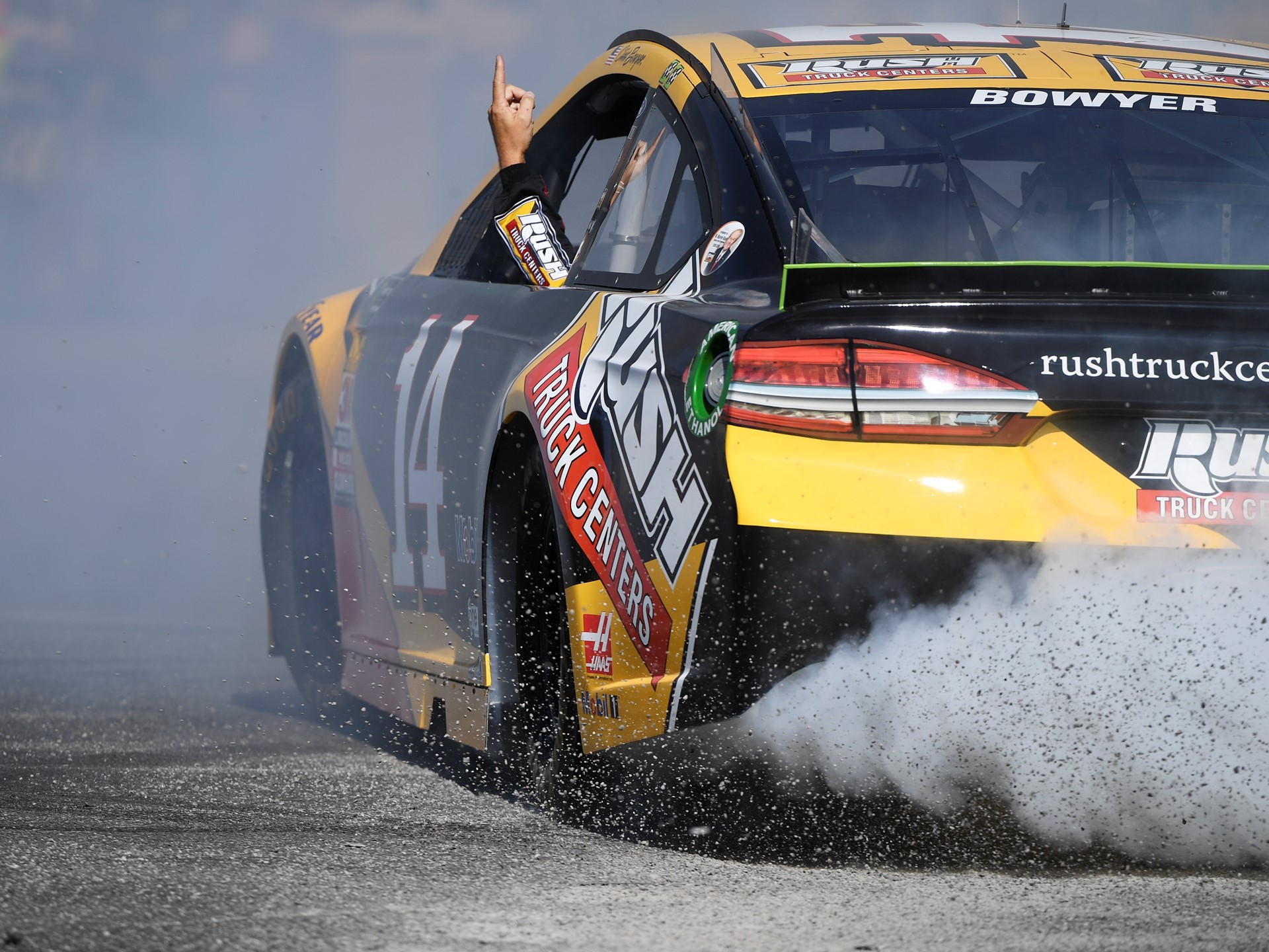 Clint Bowyer (14) points to the sky while doing donuts during the 2018 NASCAR Burnout Blvd
