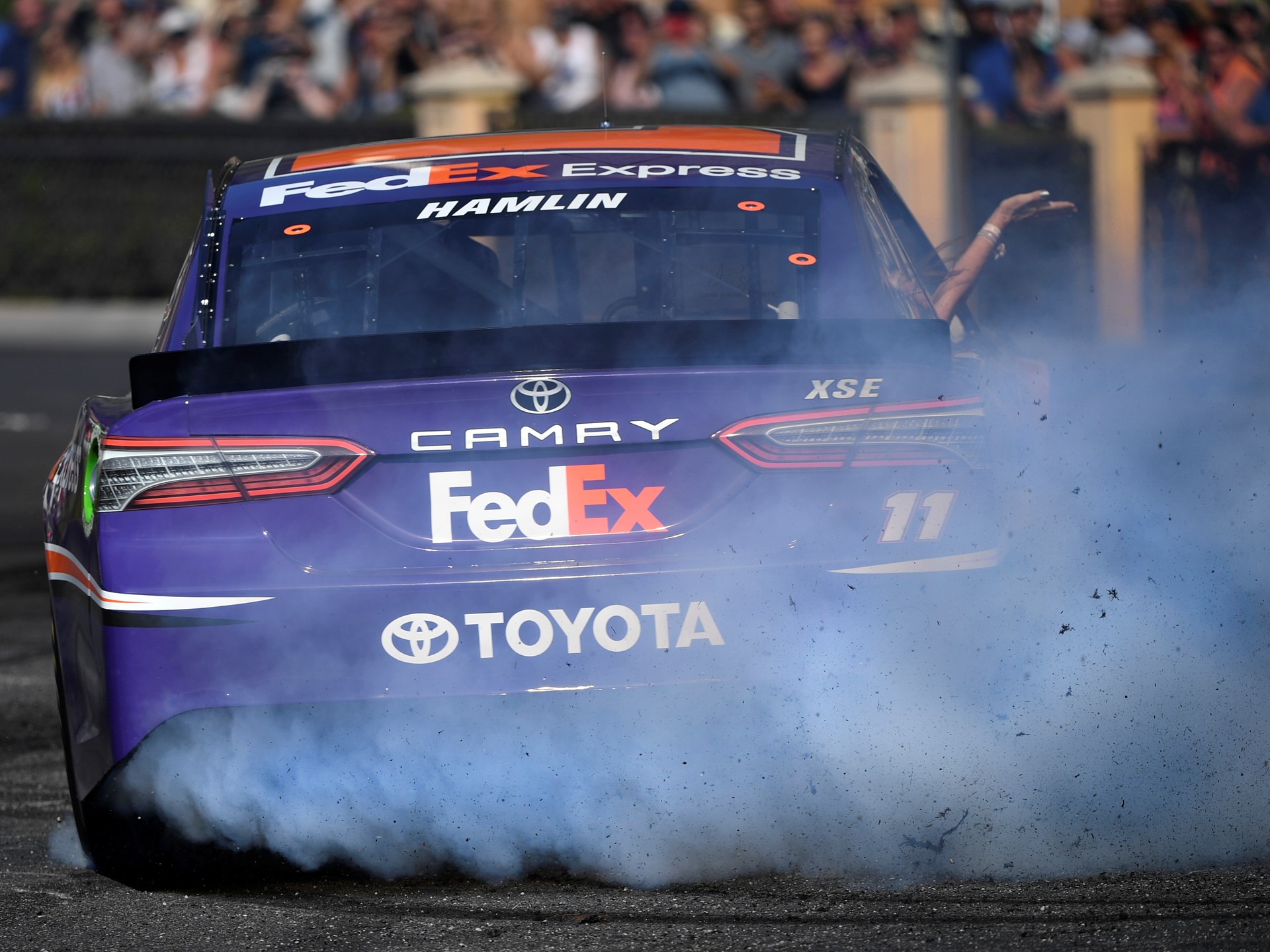Denny Hamlin (11) throws smoke and rubber during the 2018 NASCAR Burnout Blvd