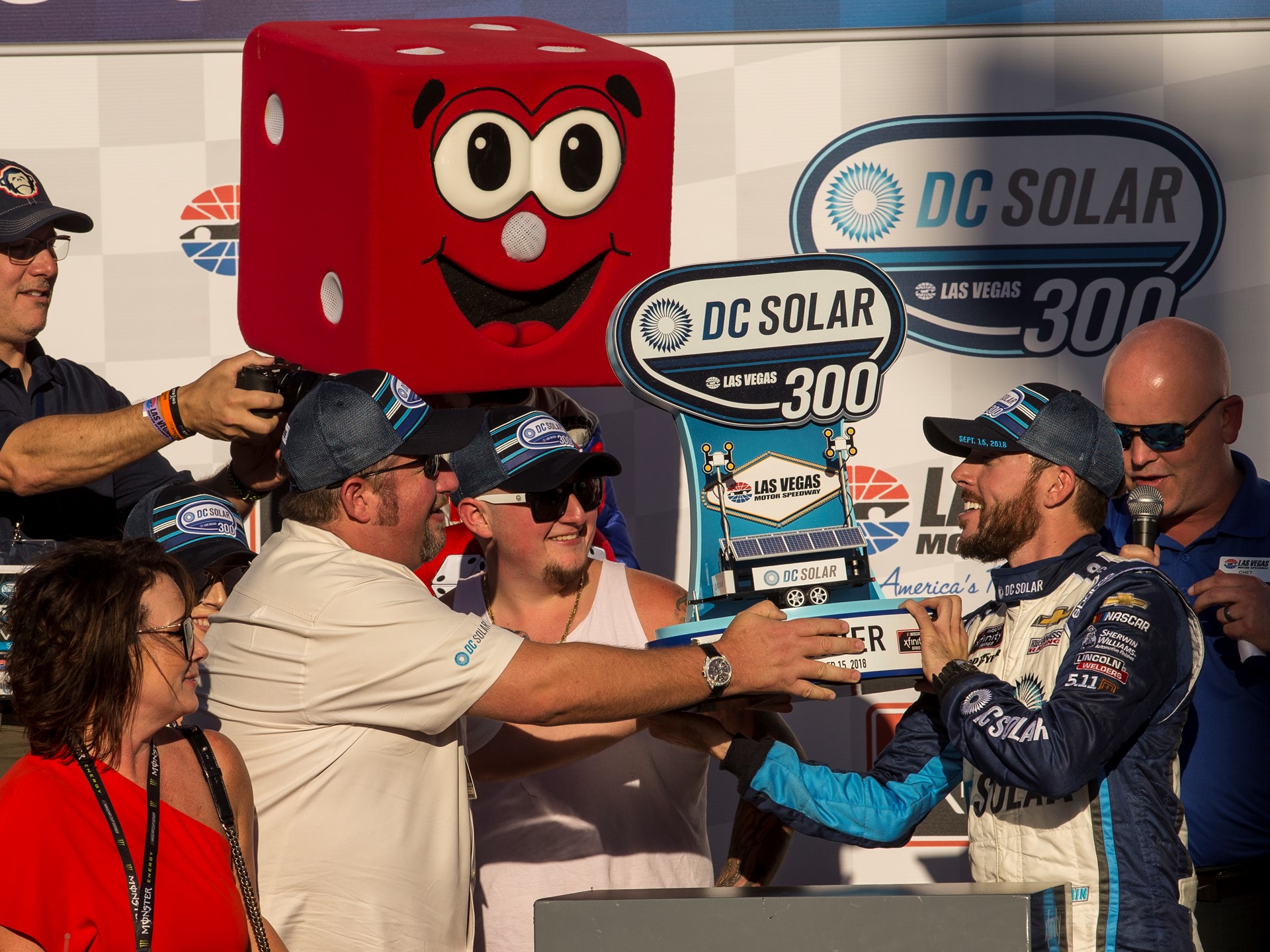 Ross Chastain #42, right, is awarded a trophy after winning the NASCAR Xfinity Series DC Solar 300
