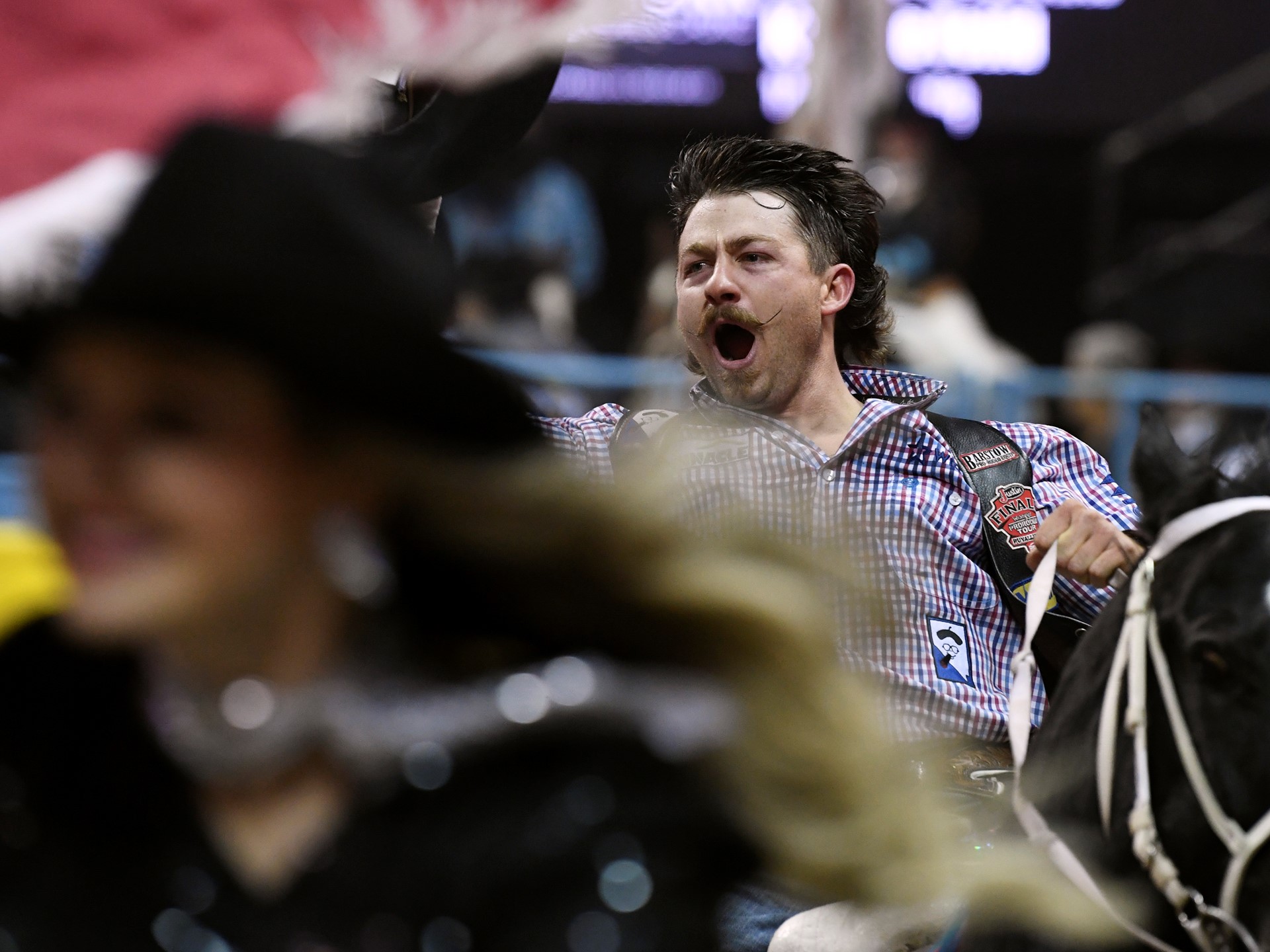 Wyatt Denny celebrates his first place finish in bareback riding