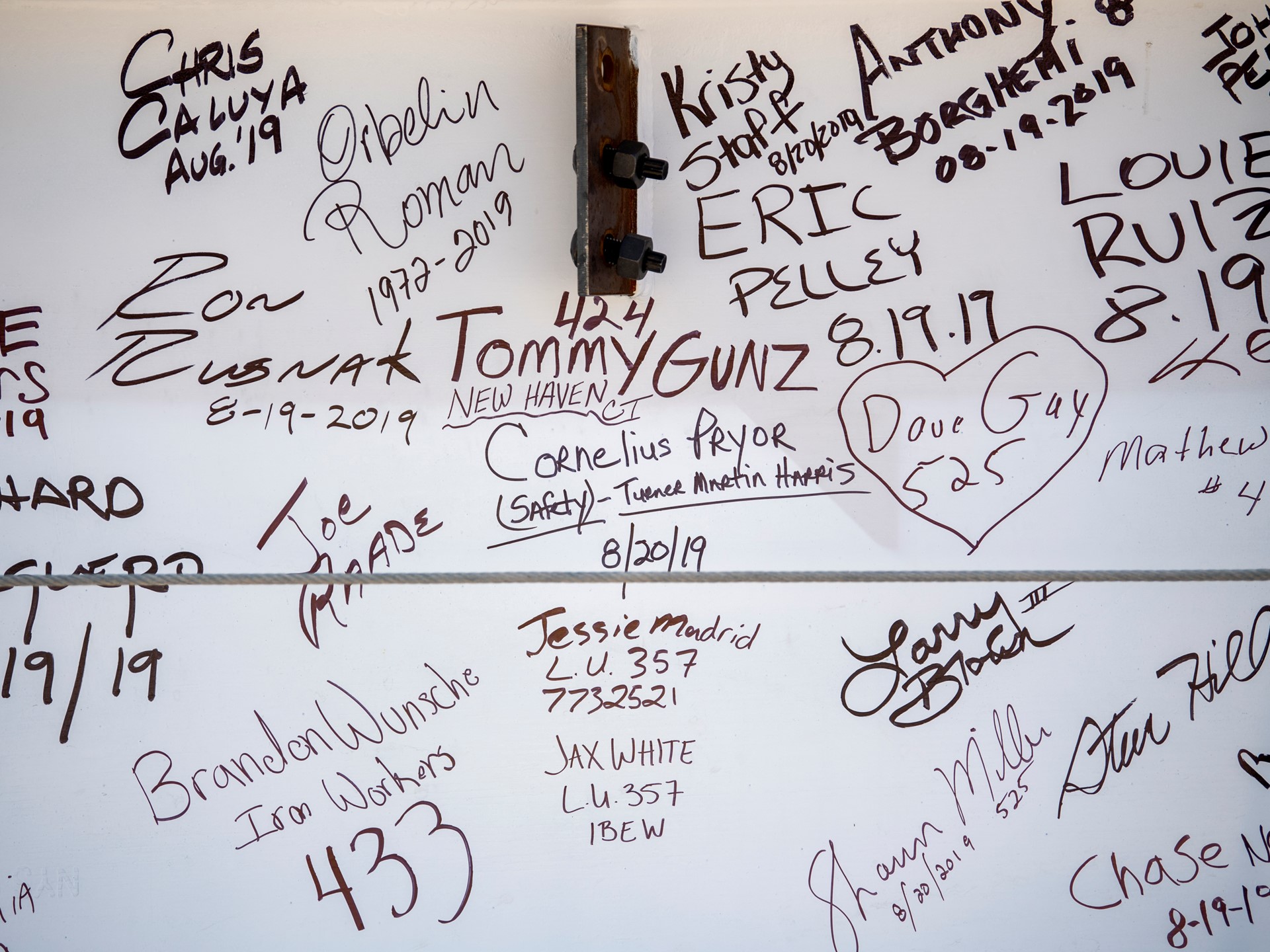 Signatures decorate the "final beam"