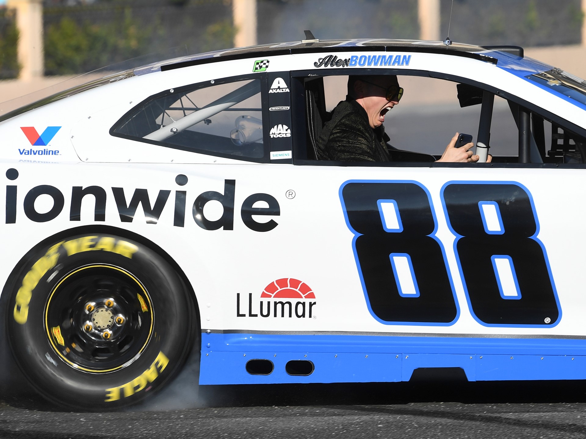 A passenger in Alex Bowman's car