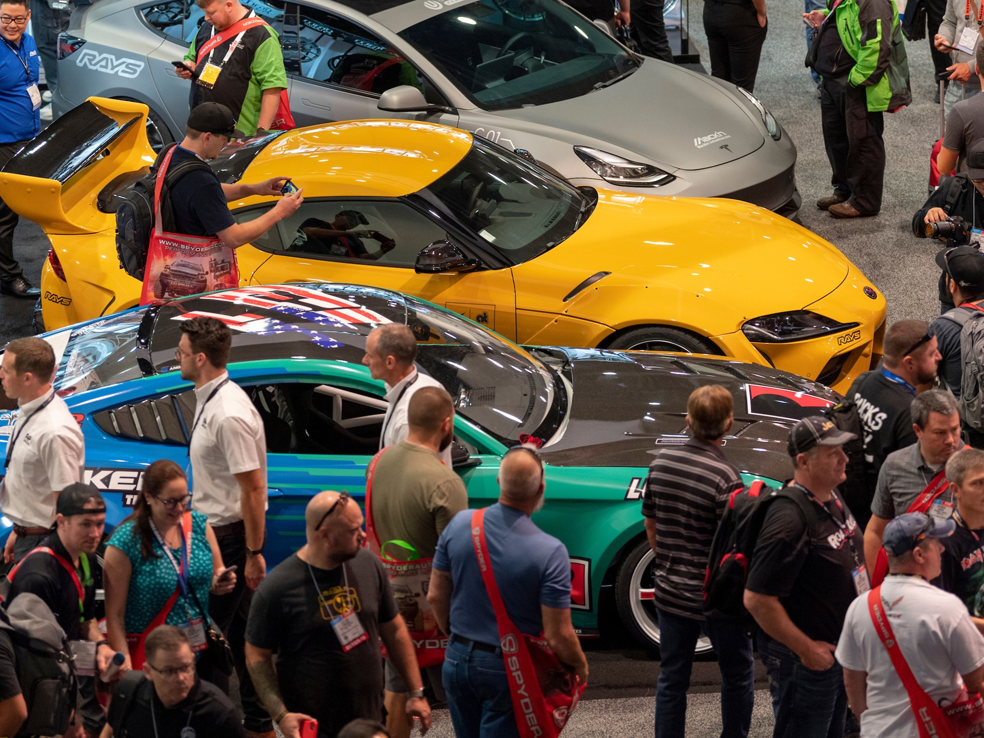 Visitors crowd cars on display