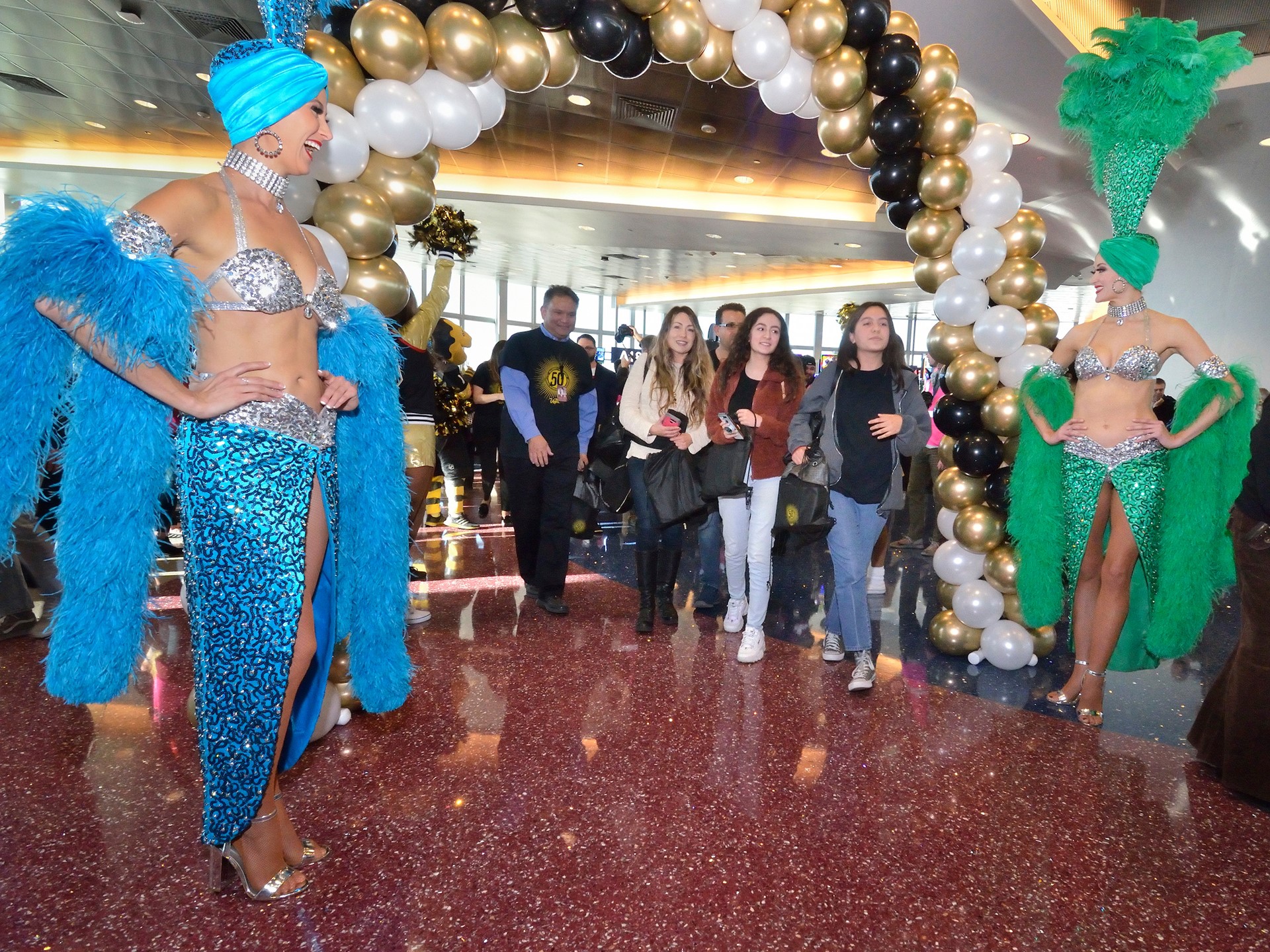 Brand ambassadors Carolin Feigs, left, and Greta Jones greet passengers from Allegiant Airlines flight 91