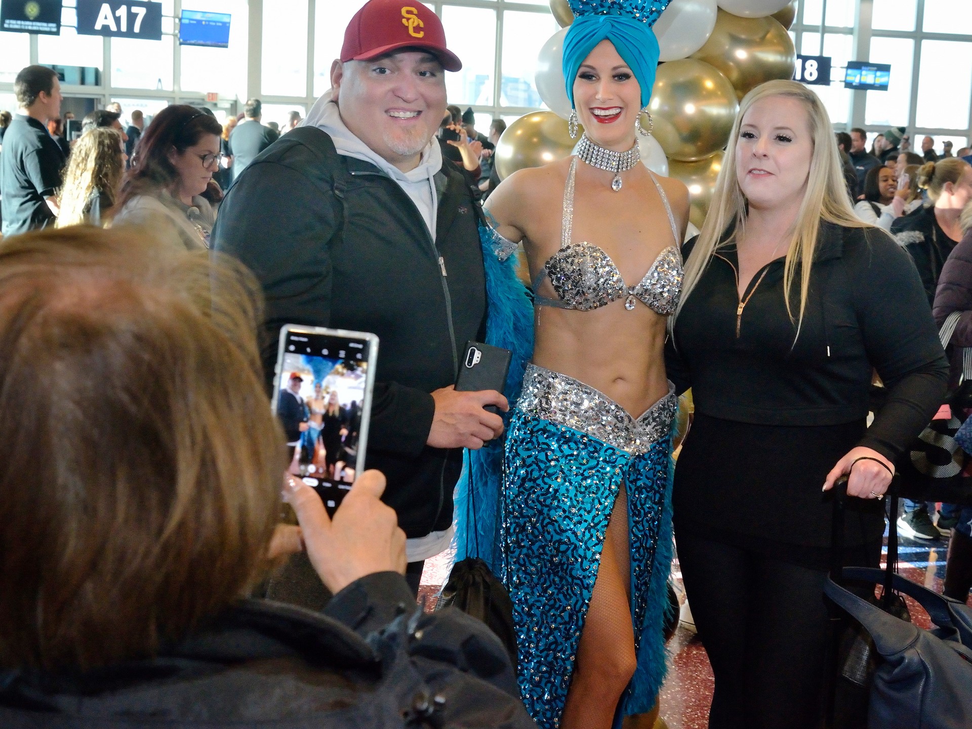 Passengers from Allegiant Airlines flight 91 have their picture taken