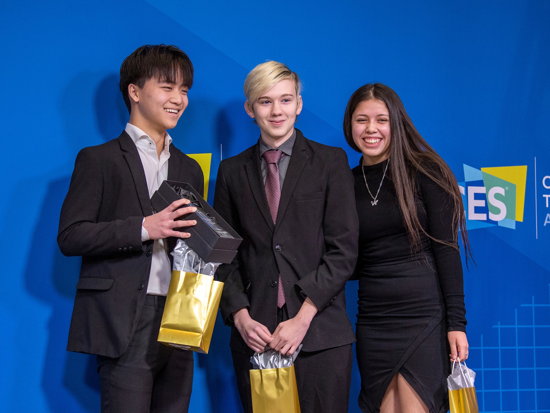 Winning Unotify teammates James Wang, from left, Josh Ferguson and Gabrielle Floratos