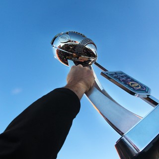 A San Diego State player hoists the championship trophy
