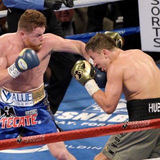 Gennady Golovkin (gray trunks) is hit with a left from Canelo Alvarez