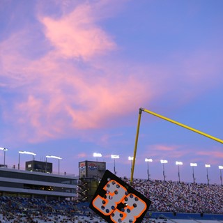 The setting sun illuminates clouds during the NASCAR Camping World Truck Series