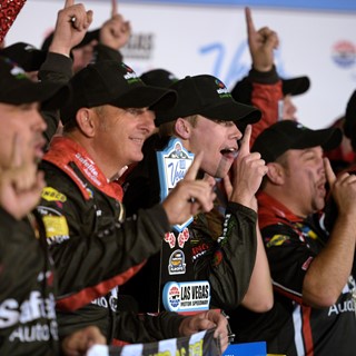 Ben Rhodes and his team cheer for photos after winning the NASCAR Camping World Truck Series