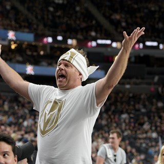 A member of the Las Vegas Golden Knights promotions crew gets the crowd to stand up