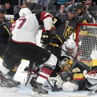Vegas Golden Knights goalie Marc-Andre Fleury (29) gets shoved into his net while making a save