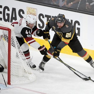 Arizona Coyotes Kevin Connauton (44) tries to keep the puck away from Vegas Golden Knight William Carrier