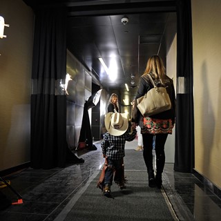 A young cowboy is escorted through the halls during the PBR World Finals