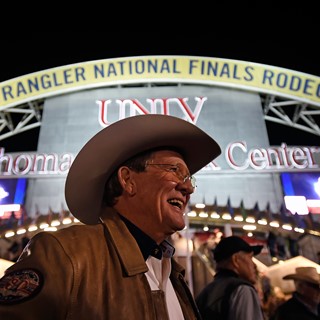Delbert Warren of Oklahoma is all smiles before as he arrives for the seventh go-round of the National Finals Rodeo