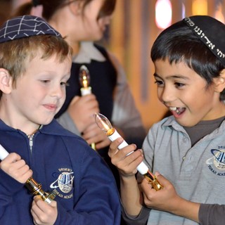 Students of the Desert Torah Academy's Children's Choir during a menorah lighting ceremony