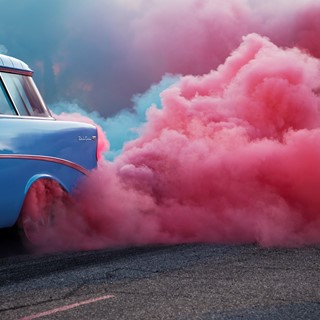 Reg Bennion sends up clouds of red and blue smoke from the tires of his 1956 Chevrolet Nomad