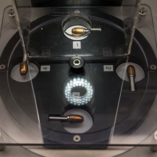 Bullets are set up to be viewed through a microscope in the Crime Lab at the Mob Museum