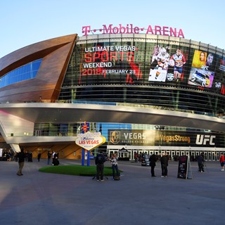 A banner ad on the side of T-Mobile Arena announces the Ultimate Vegas Sports Weekend pep rally