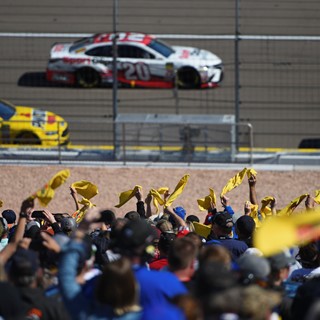 Fans wave Pennzoil flags during the Monster Energy NASCAR Cup Series Pennzoil 400