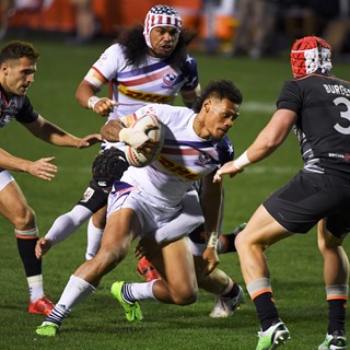 Maka Unufe of the US makes his way through England's defense during their match at the USA Sevens Rugby tournnament