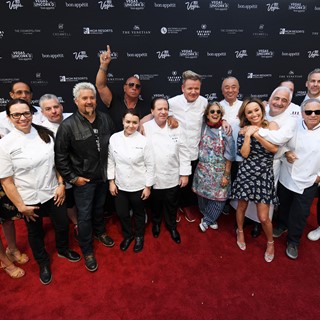Chefs pose on the red carpet during the Grand Tasting