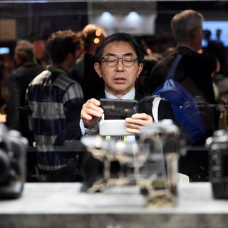An attendee takes photos of Nikon cameras