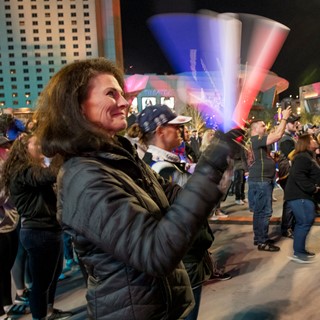 A fan claps her Vegas Golden Knights light sticks