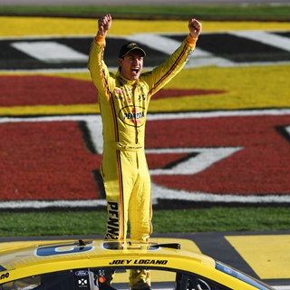 Joey Logano leaps out of his car