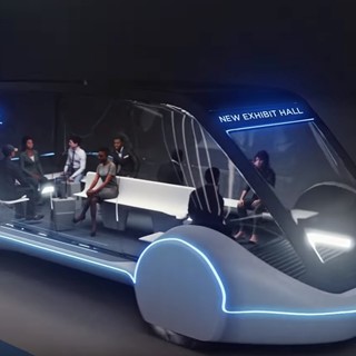 Artist conception of high-occupancy autonomous electric vehicle (AEV) running between exhibit halls