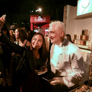 A fan takes a selfie with chef Guy Savoy