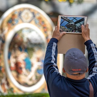 A visitor photographs the eight-foot diameter charger